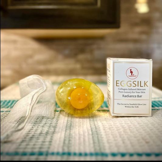 Eggsilk soap bar and packaging on a textured surface with a blurred background